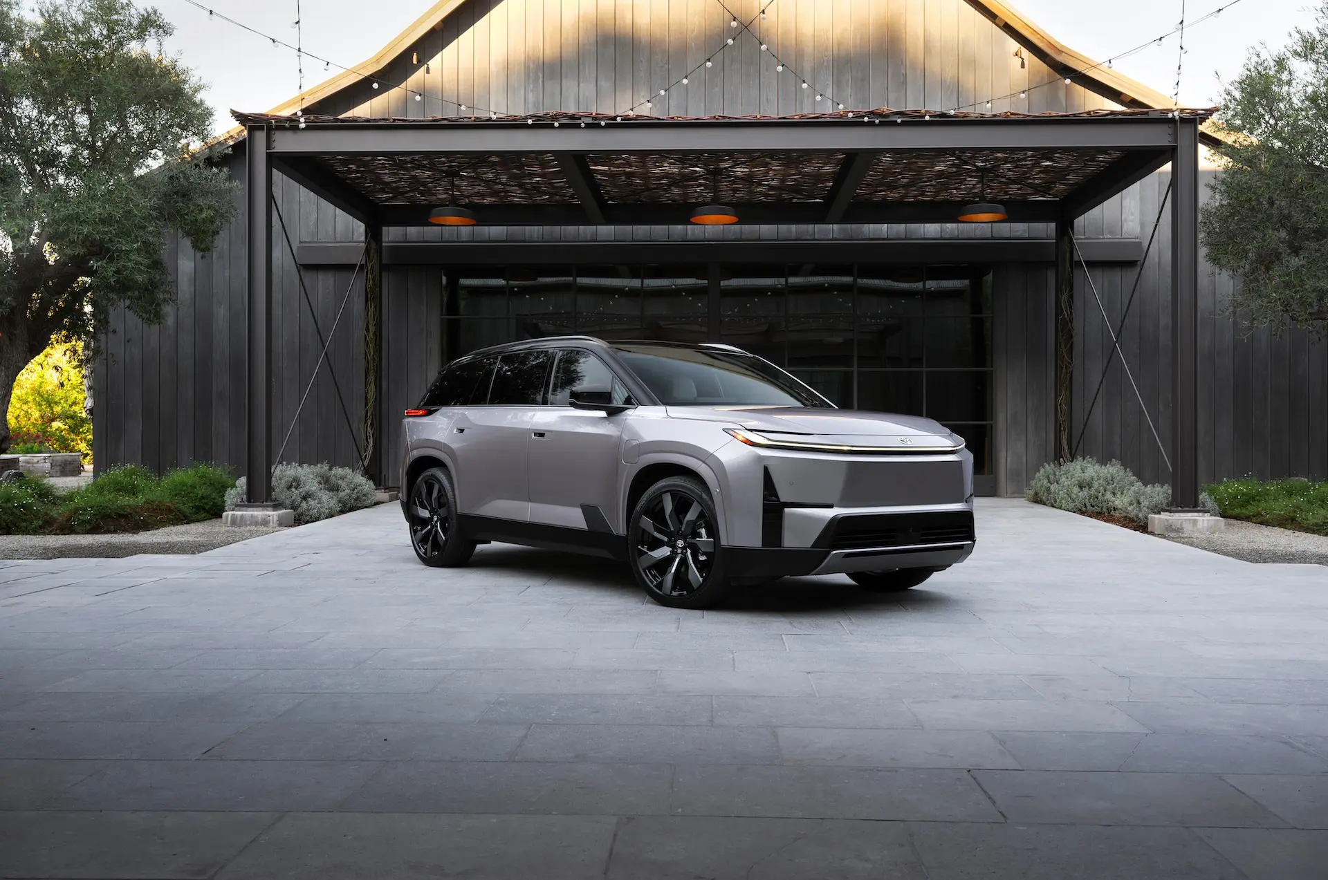 2027 Toyota Highlander electric SUV shown from the front three-quarter angle highlighting its redesigned exterior and modern EV styling.