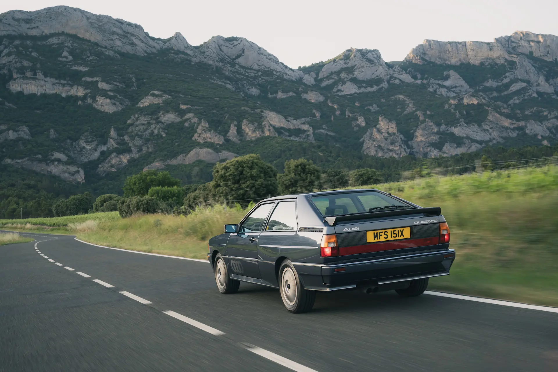 1982-Audi-Quattro-Coupe-rear-qtr-driving-car-back-catalogue